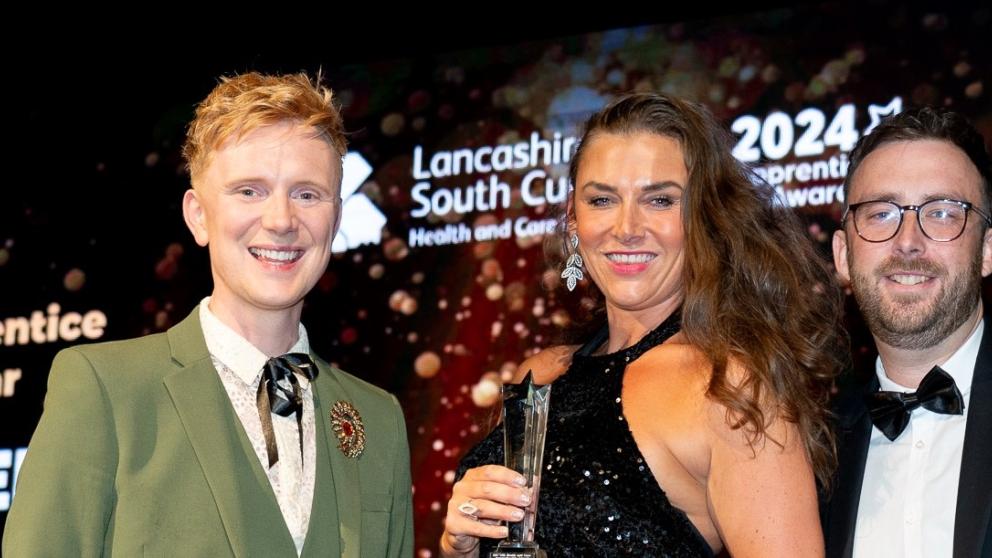 Holly Anderson receives an award from Owain Wyn Evans