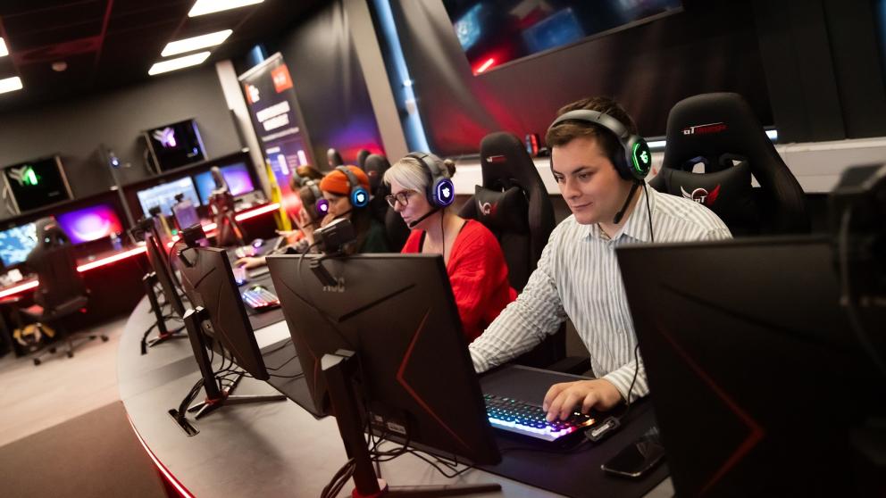 Staff using gaming workstations in the Esports Suite, Salford Business School