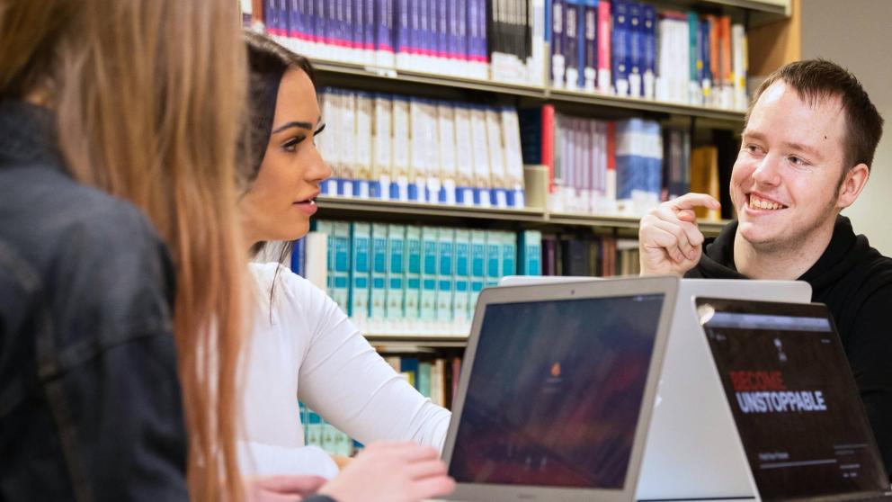 Students around a table in Clifford Whitworth Library, University of Salford