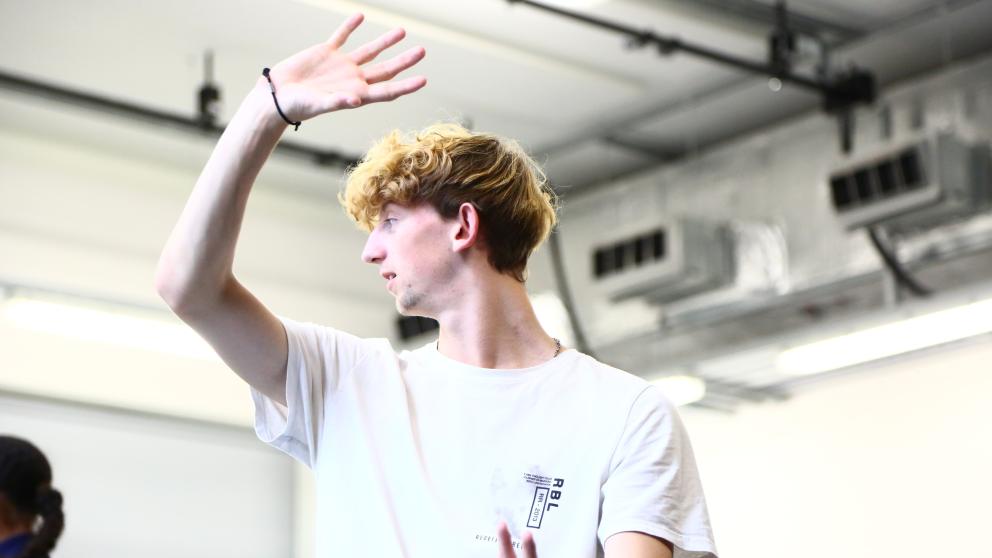 Louis Harris pulls a dancing pose in a dance studio
