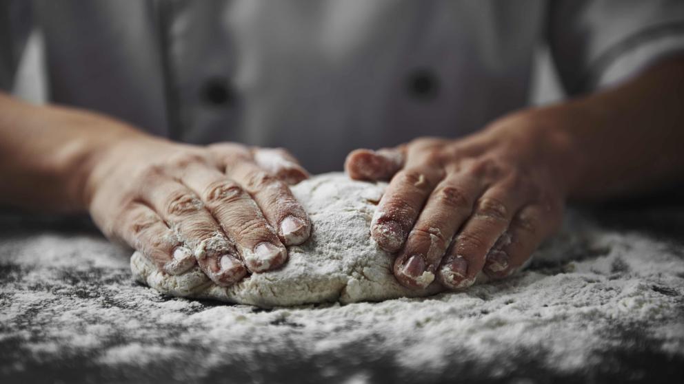 Hands kneading dough