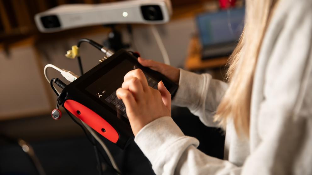 Acoustics student using electrical equipment