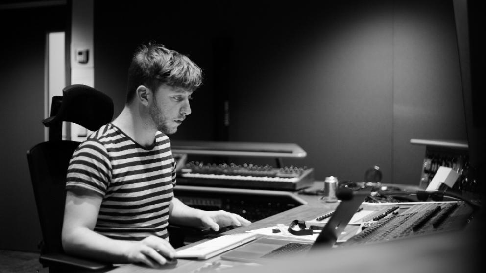 Person working in university of salford sound mixing studio.