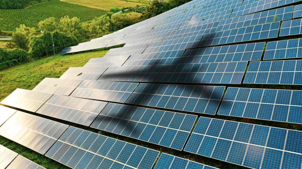 Shadow of an airplane on solar panels