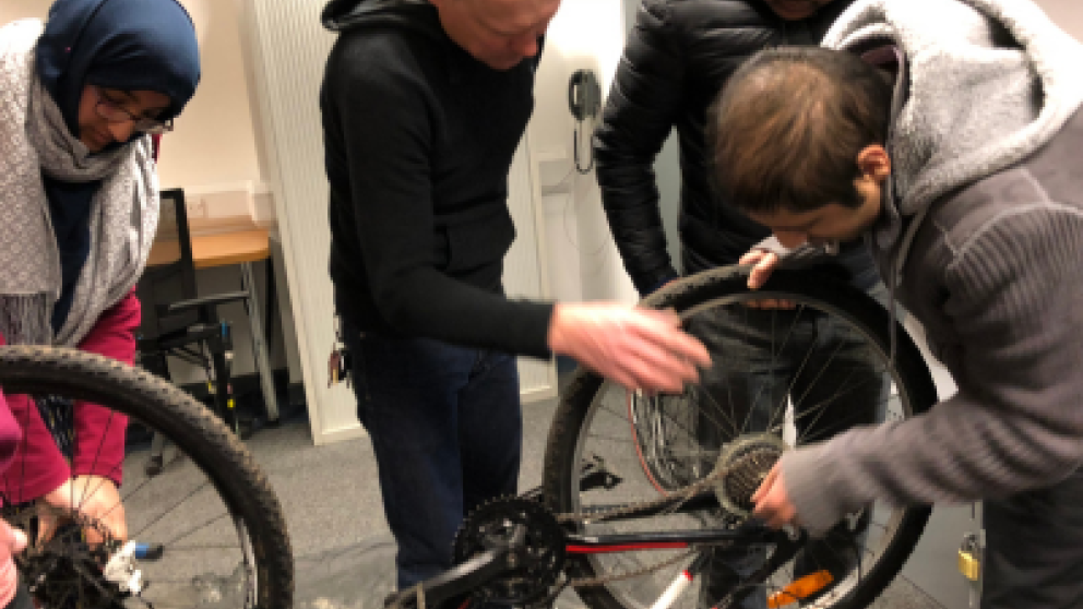 A group of people fixing a bicycle
