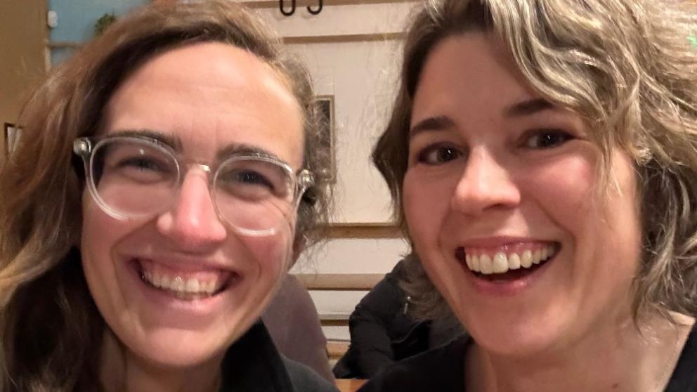 Two students smiling at the camera