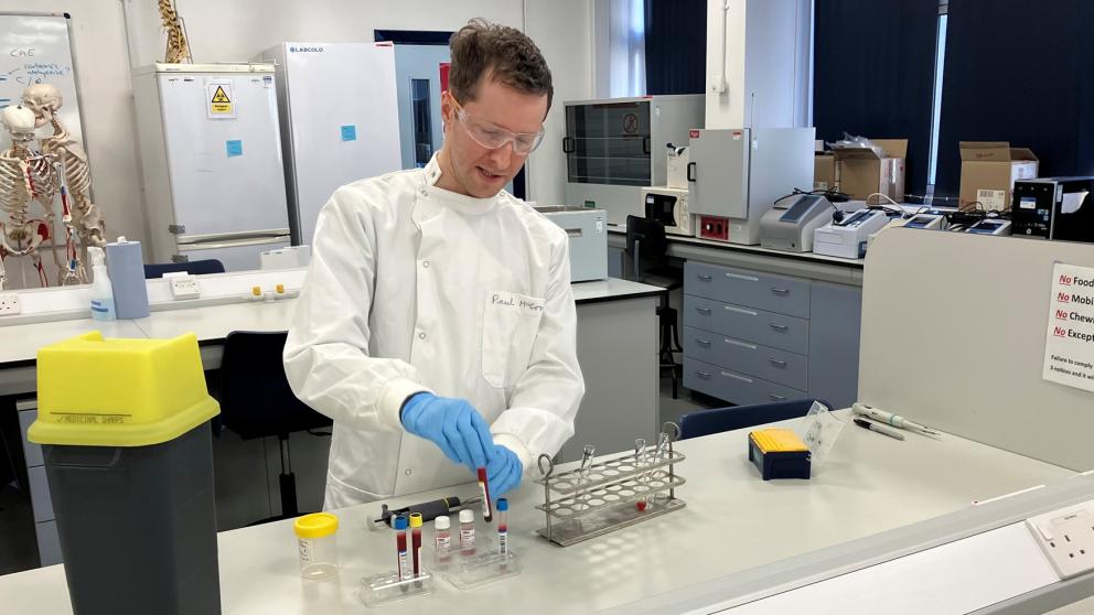 Apprentice Paul McCormick working with laboratory equipment