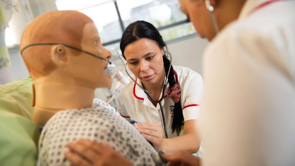 Nursing students using a dummy in the Simulation Suite, University of Salford