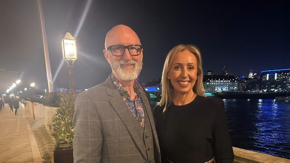 Nic Beech and Cat McCusker from PwC on balcony overlooking river at House of Lords 