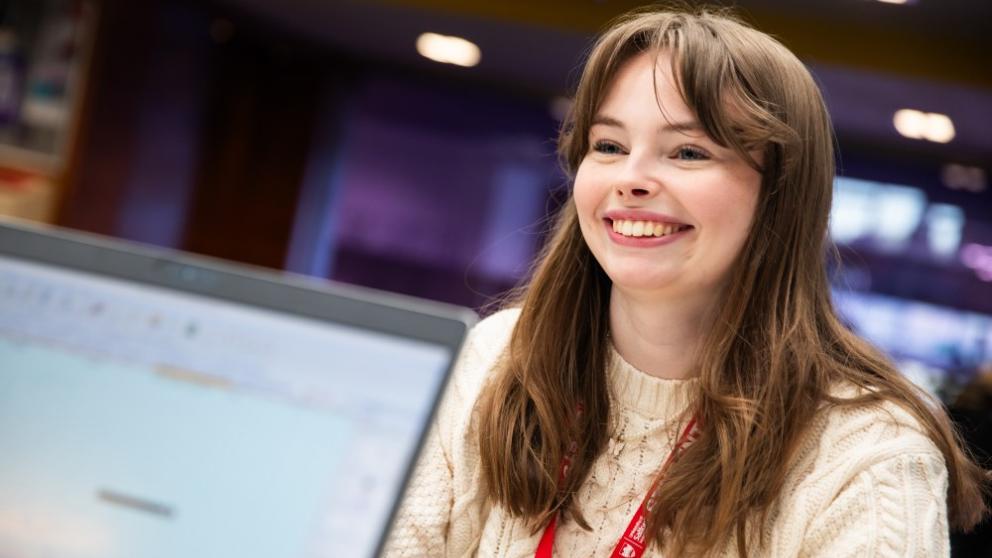 A student at the askUS counter in University House, University of Salford