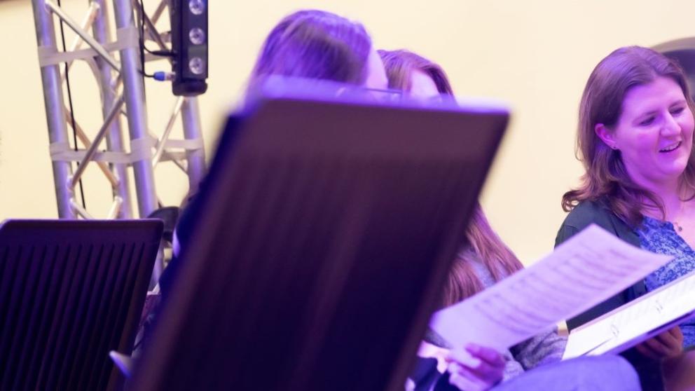 A choir singing from music sheets