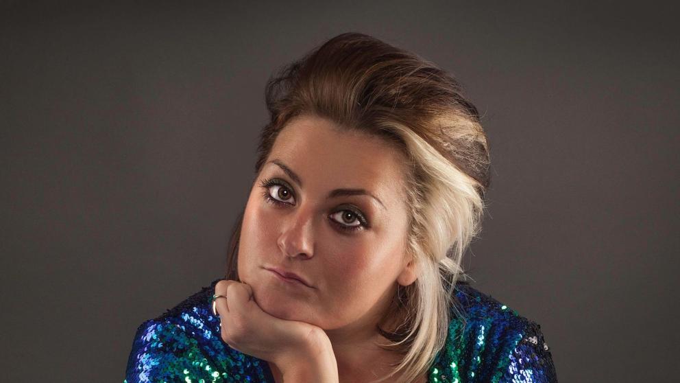 Kiri poses in front of a black background