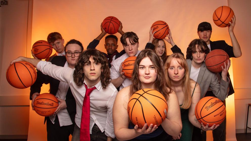 Students pose for the camera with basketballs in a promotion shoot