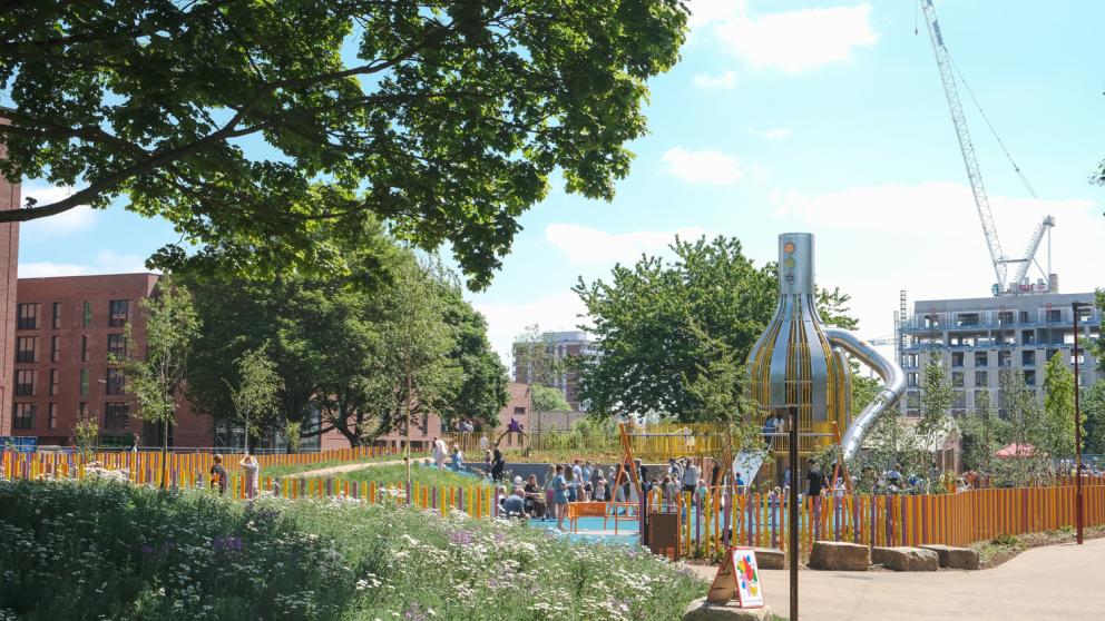 Play park among trees and landscaped path in Ancoats Manchester