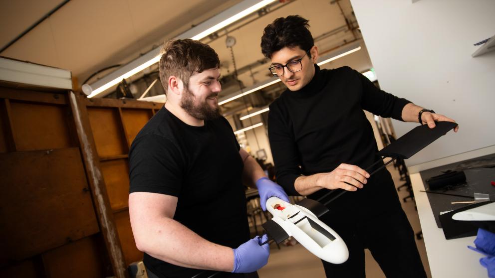 Aeronautical Engineering students working with a model airplane