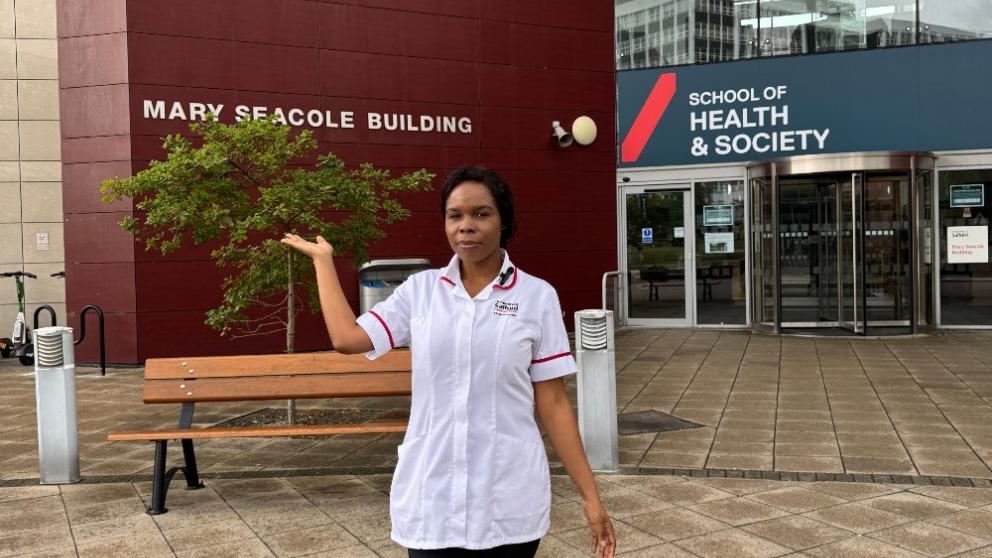 Olivera outside Mary Seacole building in her student nurse uniform