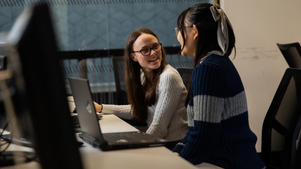 two students sat at computers
