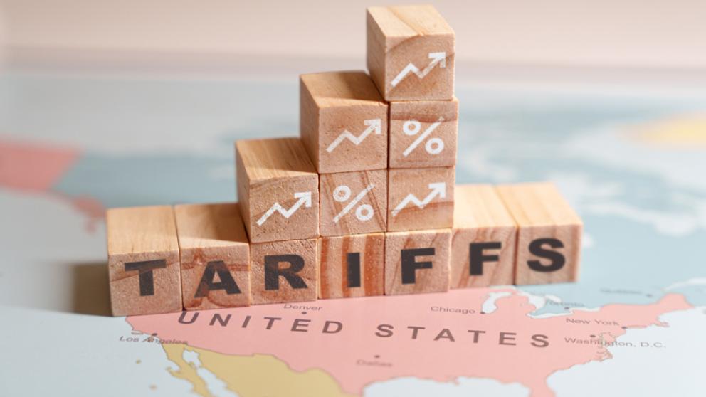 Building blocks with graph and tariff lettering on top of a map of the USA