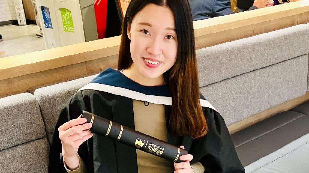 Wing at graduation holder her scroll