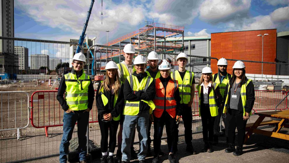 A group in front of a building site 