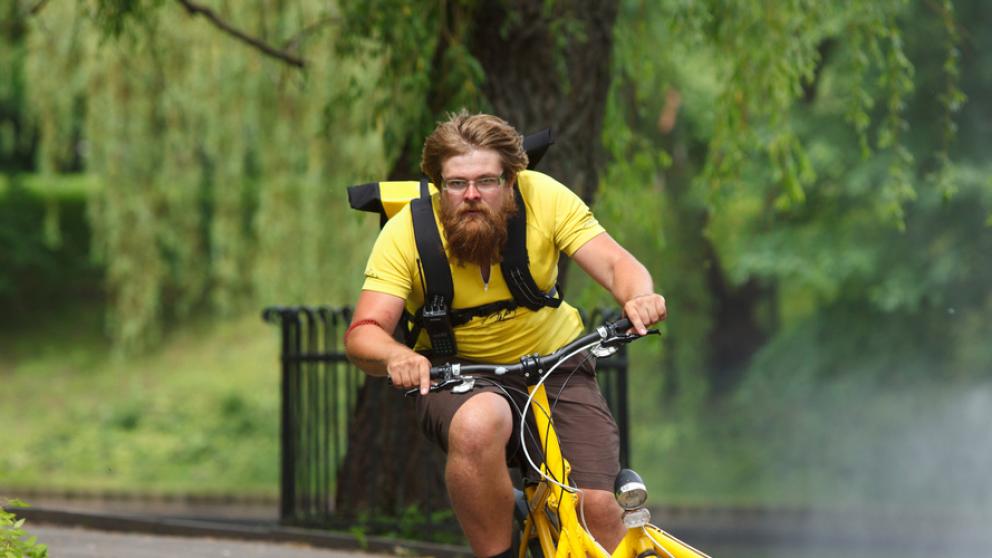 Bicycle messenger riding electric cargo bike