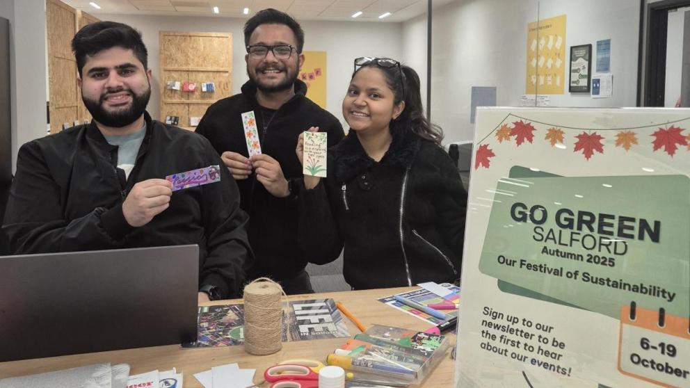 Students smiling and holding their crafts they had created during a workshop.