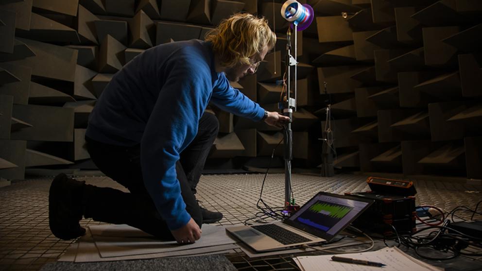 Student working on equipment in the anechoic chamber, Newton Building, University of Salford