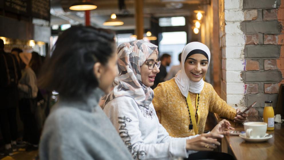 Three students in Mackie Mayor market, Manchester