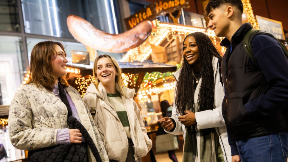 Students at the The Witch House stall located on New Cathedral Street at the Manchester Christmas Markets