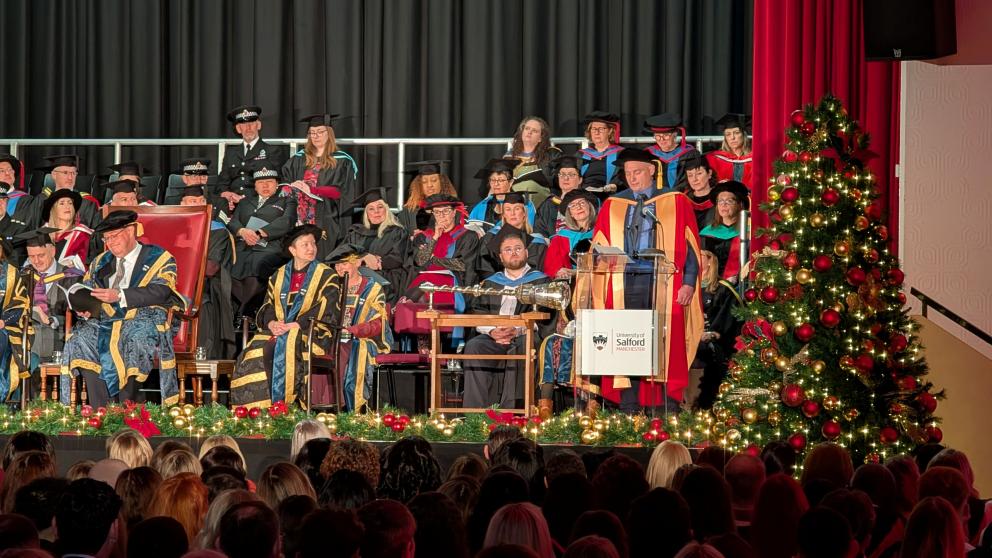 Academics sitting on stage during a graduation ceremony