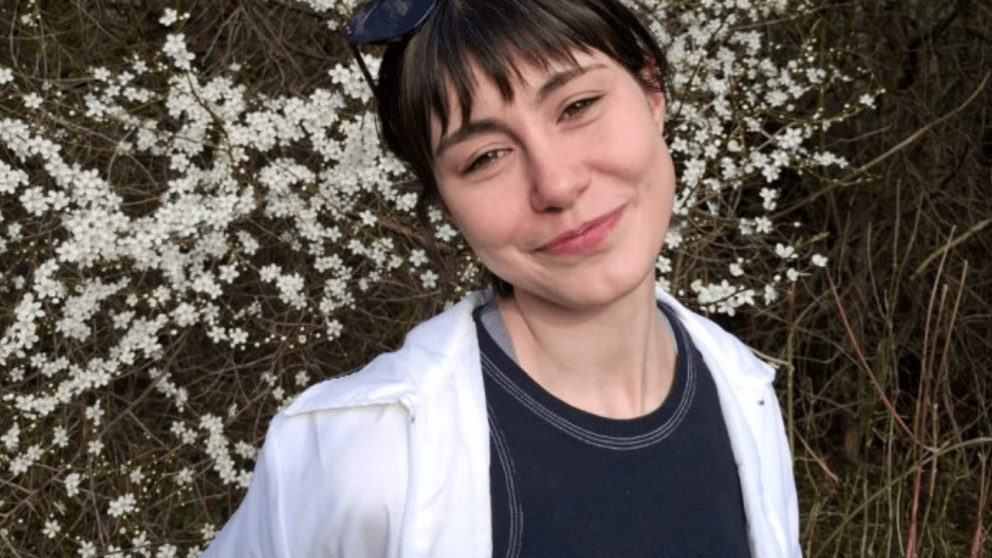 A woman smiles at the camera 