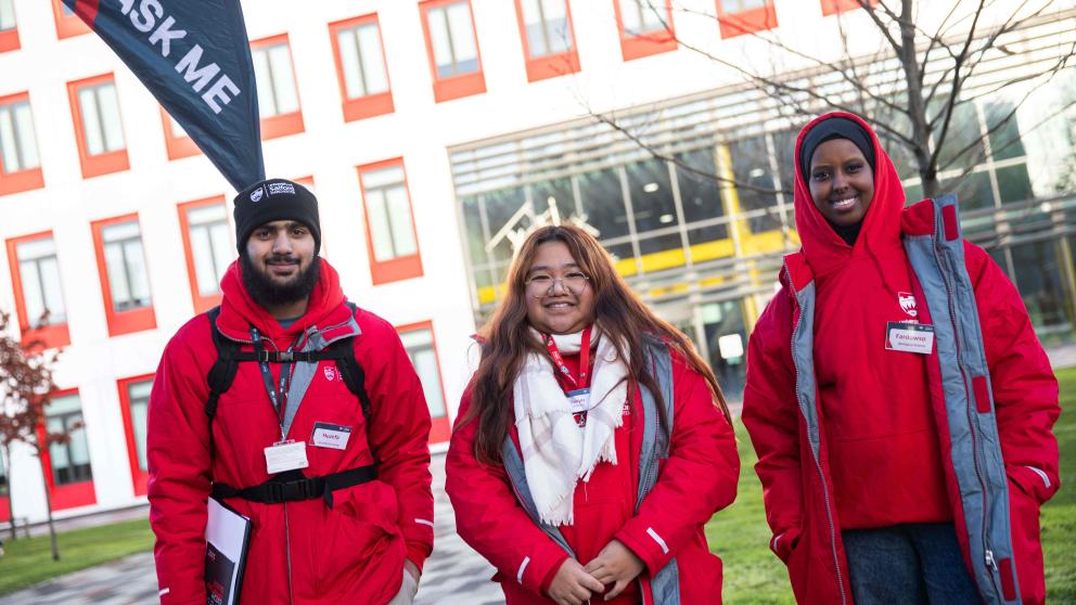 Three Student Ambassadors in front of University of Salford building
