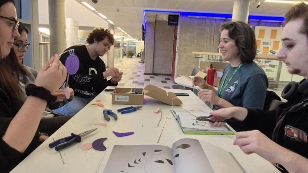 People sat round a table crafting.