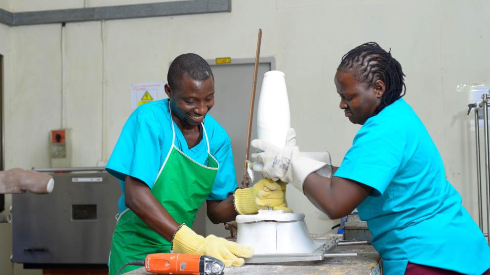 Two prosthetists working on a cast