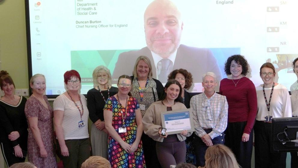 Gabby is pictured with her employer, Duncan, Andrea and the University team web