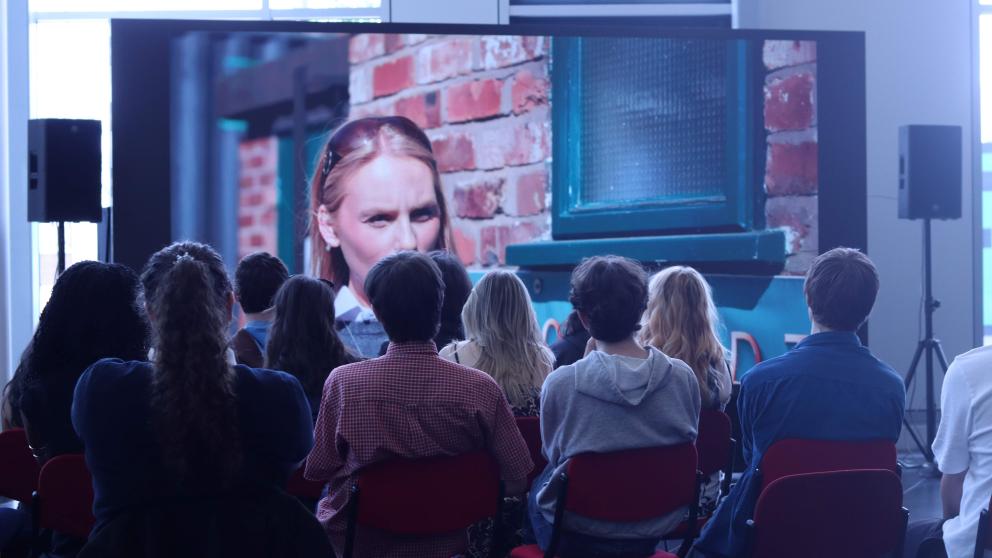 Students watching a film on a cinema screen 