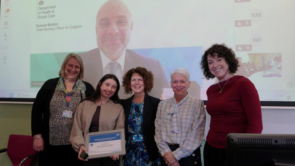 Gabby is pictured receiving her awards alongside her employer, representatives from the University and NHS England