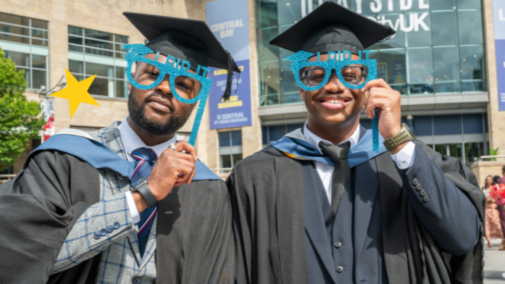 Graduates posing with glasses