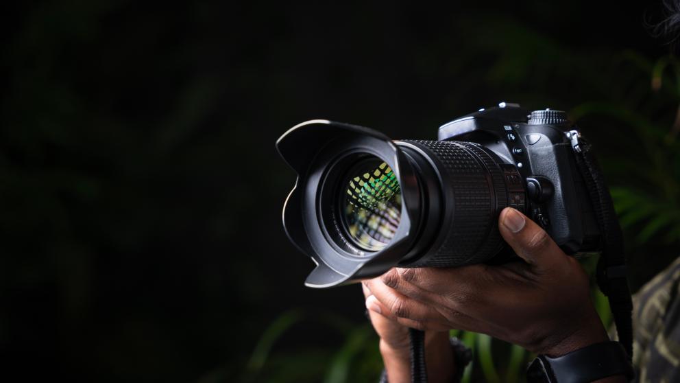 A camera in front of a black screen