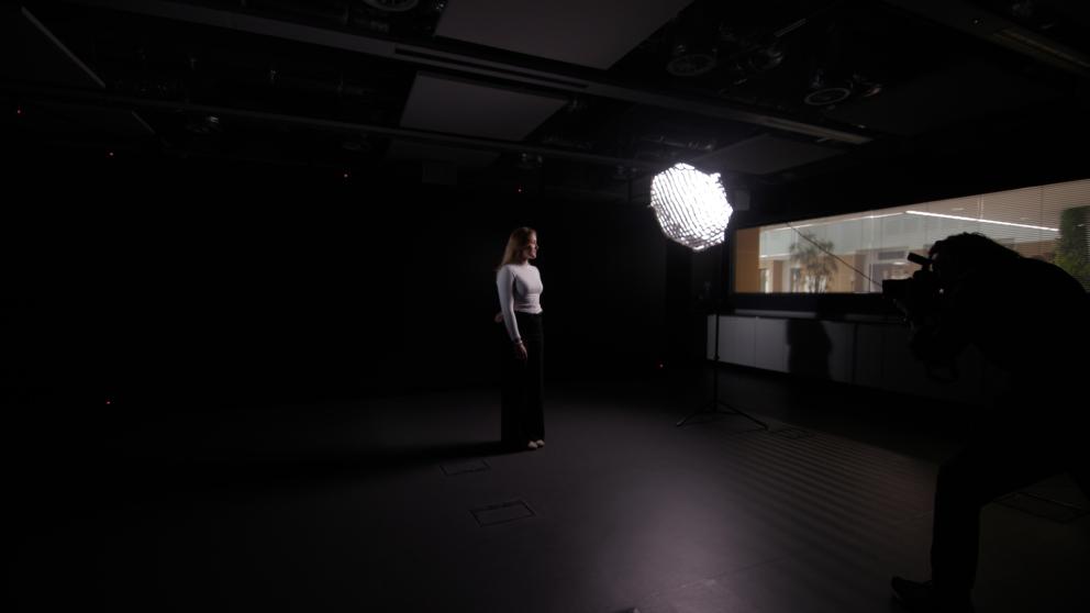 A photographer taking a photo of Sri Hollema in a studio