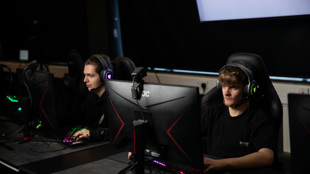 students on computers in esports lab, salford business school