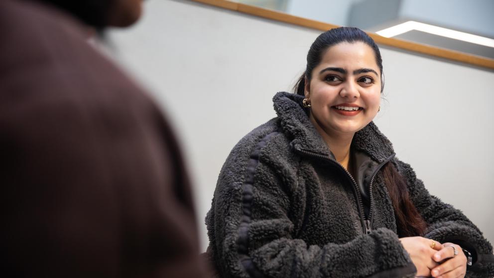 student sat smiling at person sat opposite
