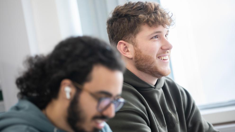 student smiling in business lecture