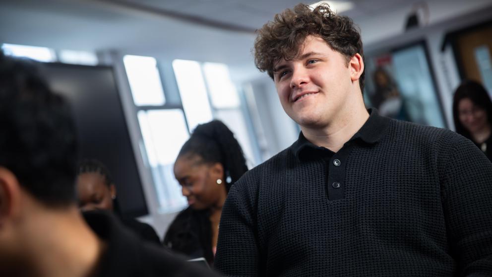 student smiling in business lecture
