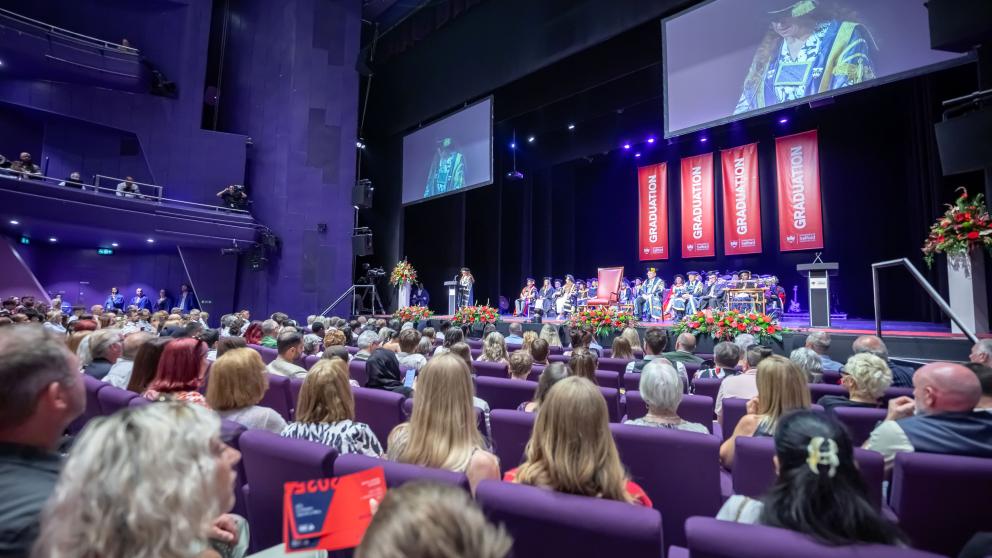 A wide shot of the graduation stage at the Lowry theatre