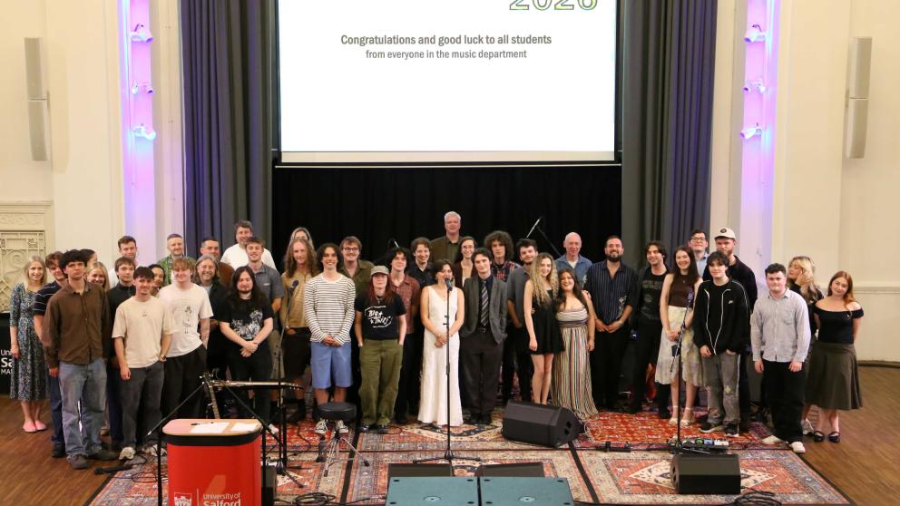 Music students and staff standing together on a stage