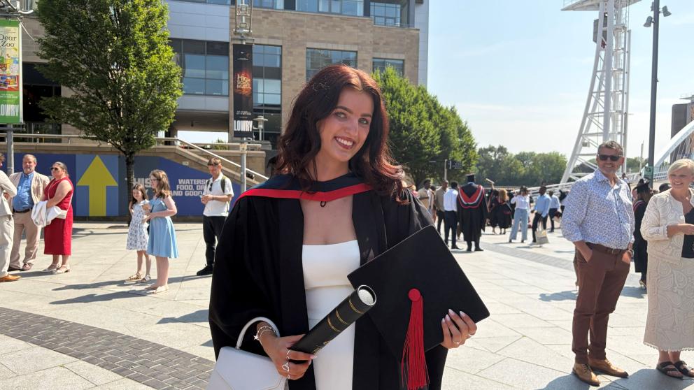 Olivia is pictured in her graduation cap and gown