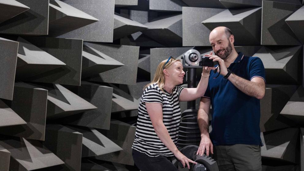 Two students working on equipment in the anechoic chamber, Newton Building, University of Salford