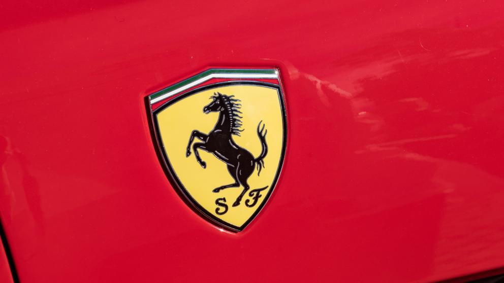 Ferrari logo on red backdrop/car