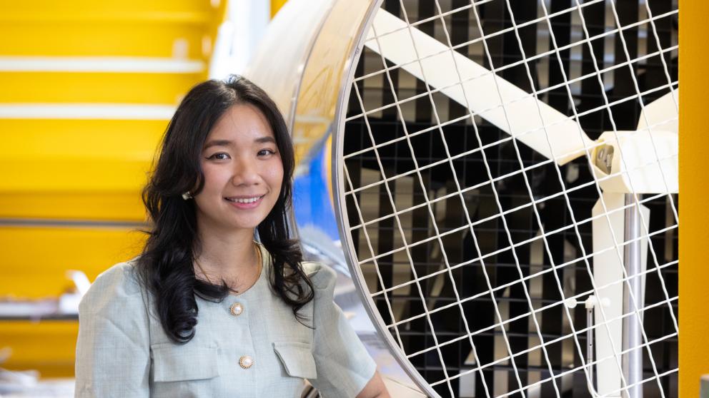 Colleague standing next to a large industrial wind tunnel fan